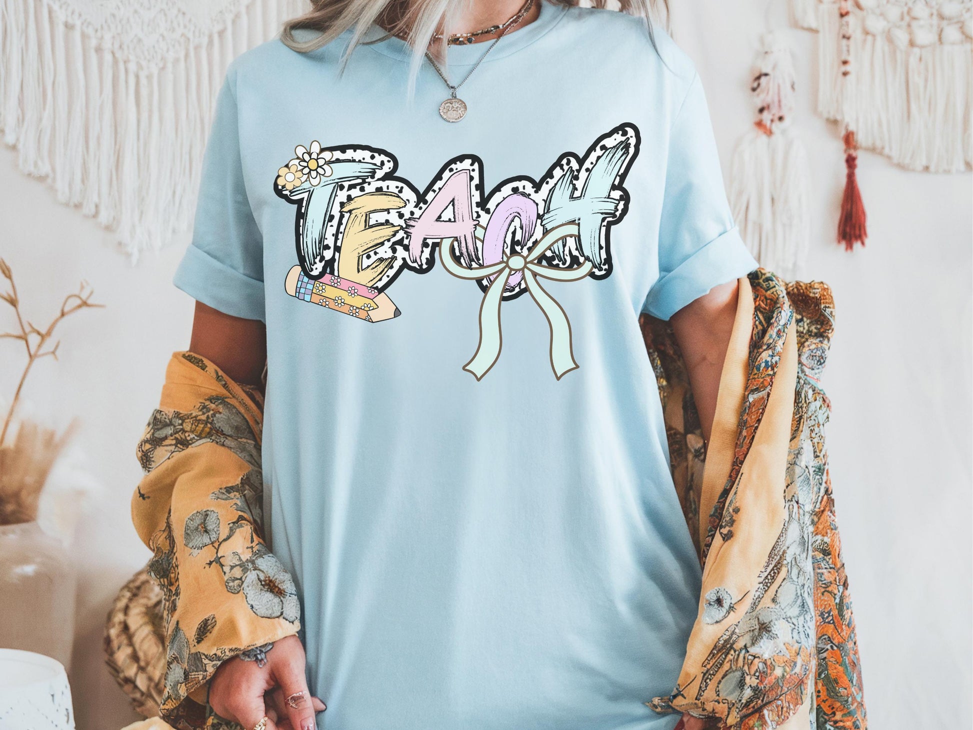 Women’s light blue teach t-shirt with the word teach in a pastel dalmation dot  print, gift for teachers
