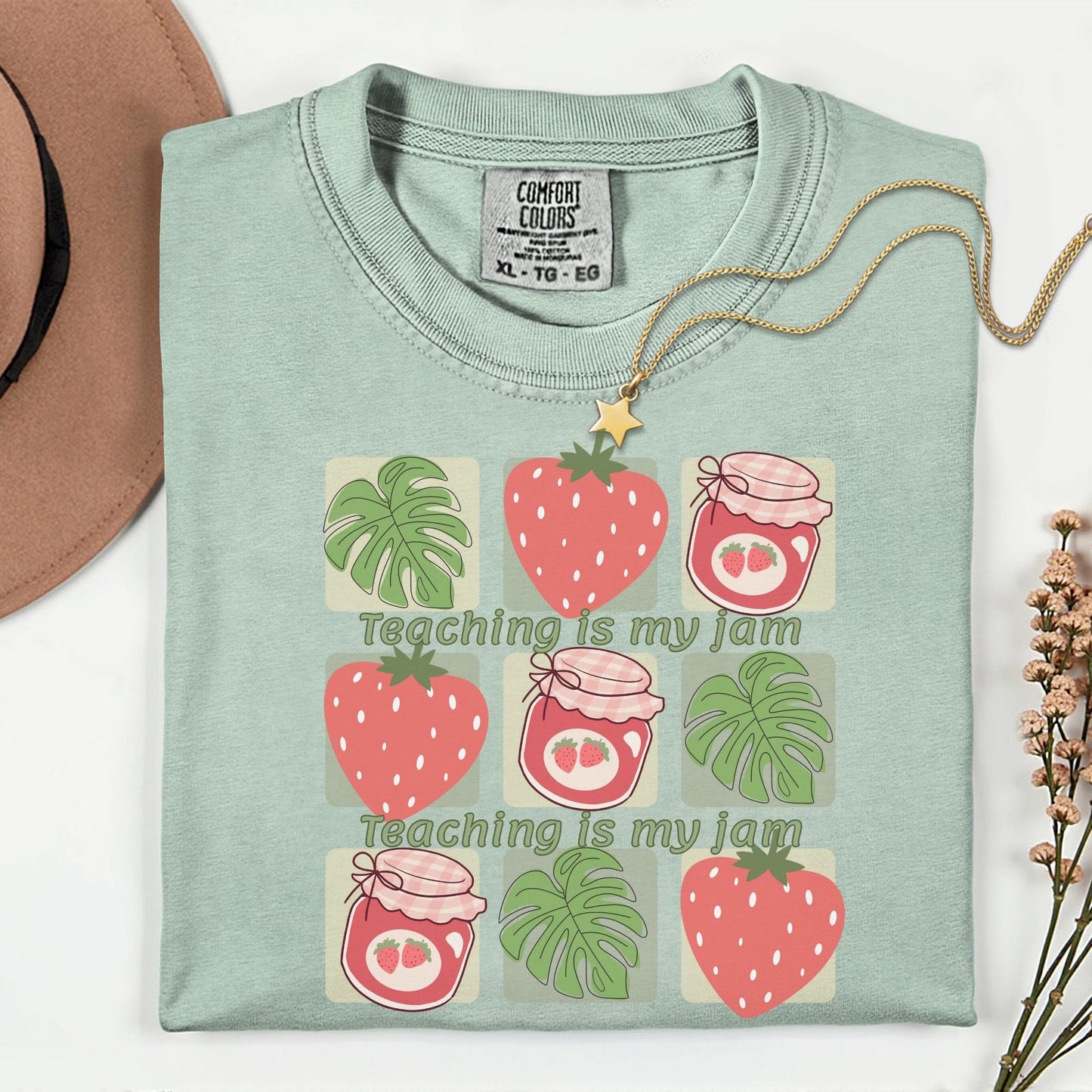 Women’s green t-shirt for teachers with the phrase teaching is my jam, strawberry and green leaves perfect teacher gift.