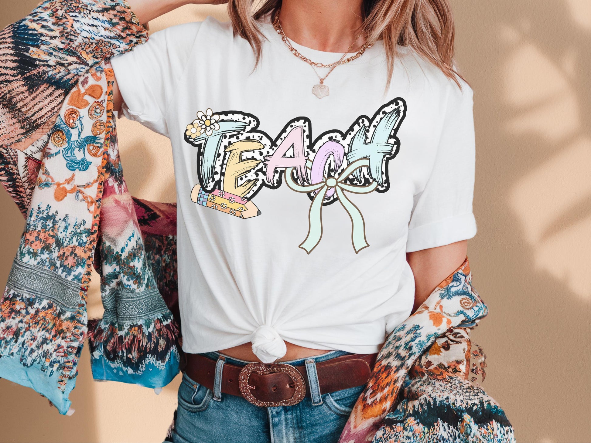 Women’s white teach t-shirt with the word teach in a pastel dalmation dot  print, gift for teachers