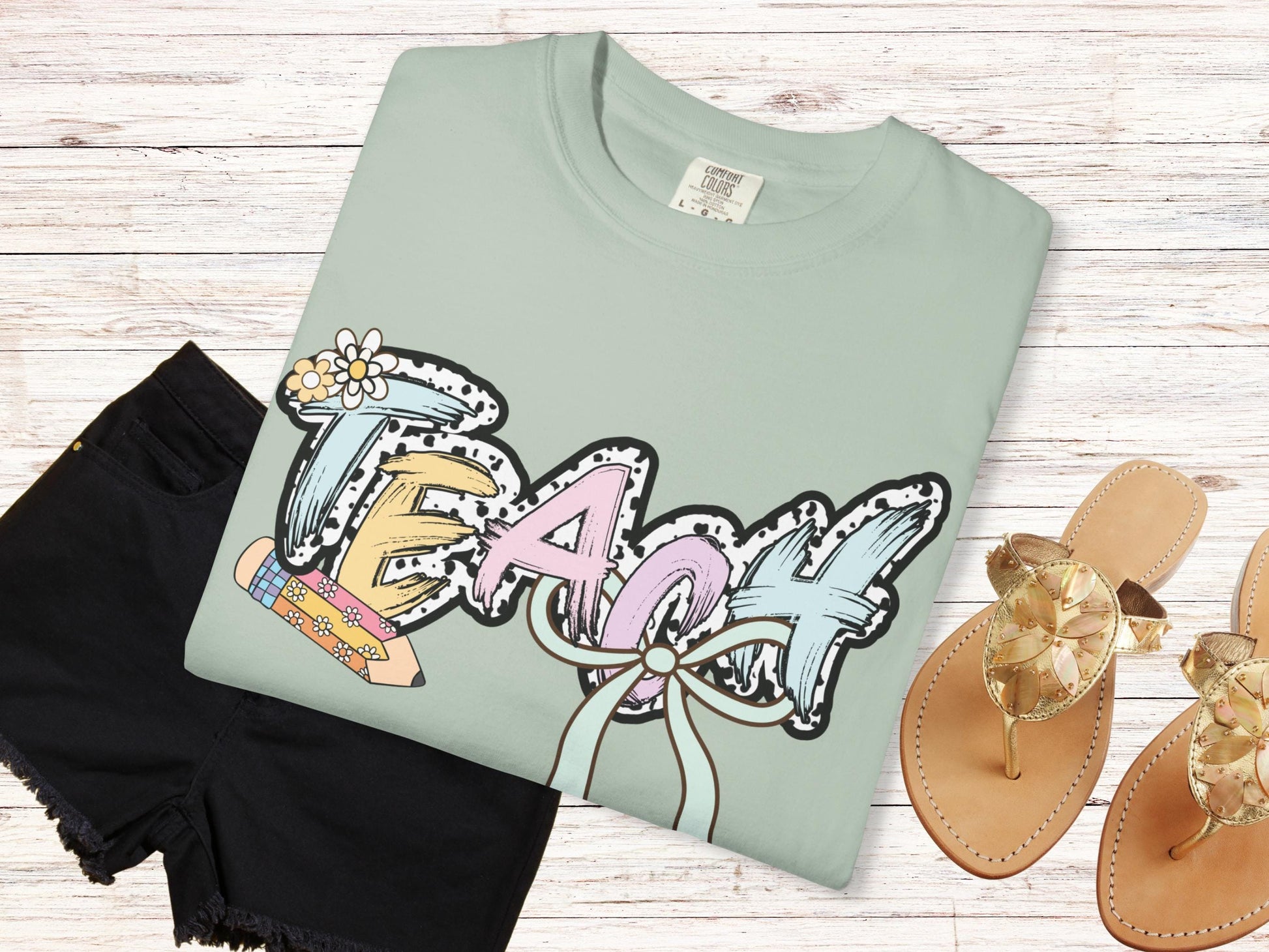 Women’s green teach t-shirt with the word teach in a pastel dalmation dot  print, gift for teachers