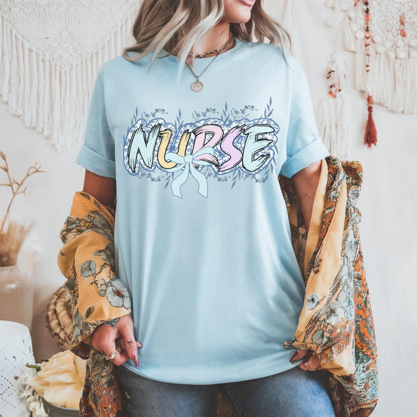 Women’s light blue nurse t-shirt with the word nurse in a pastel blue floral print, gift for nurses