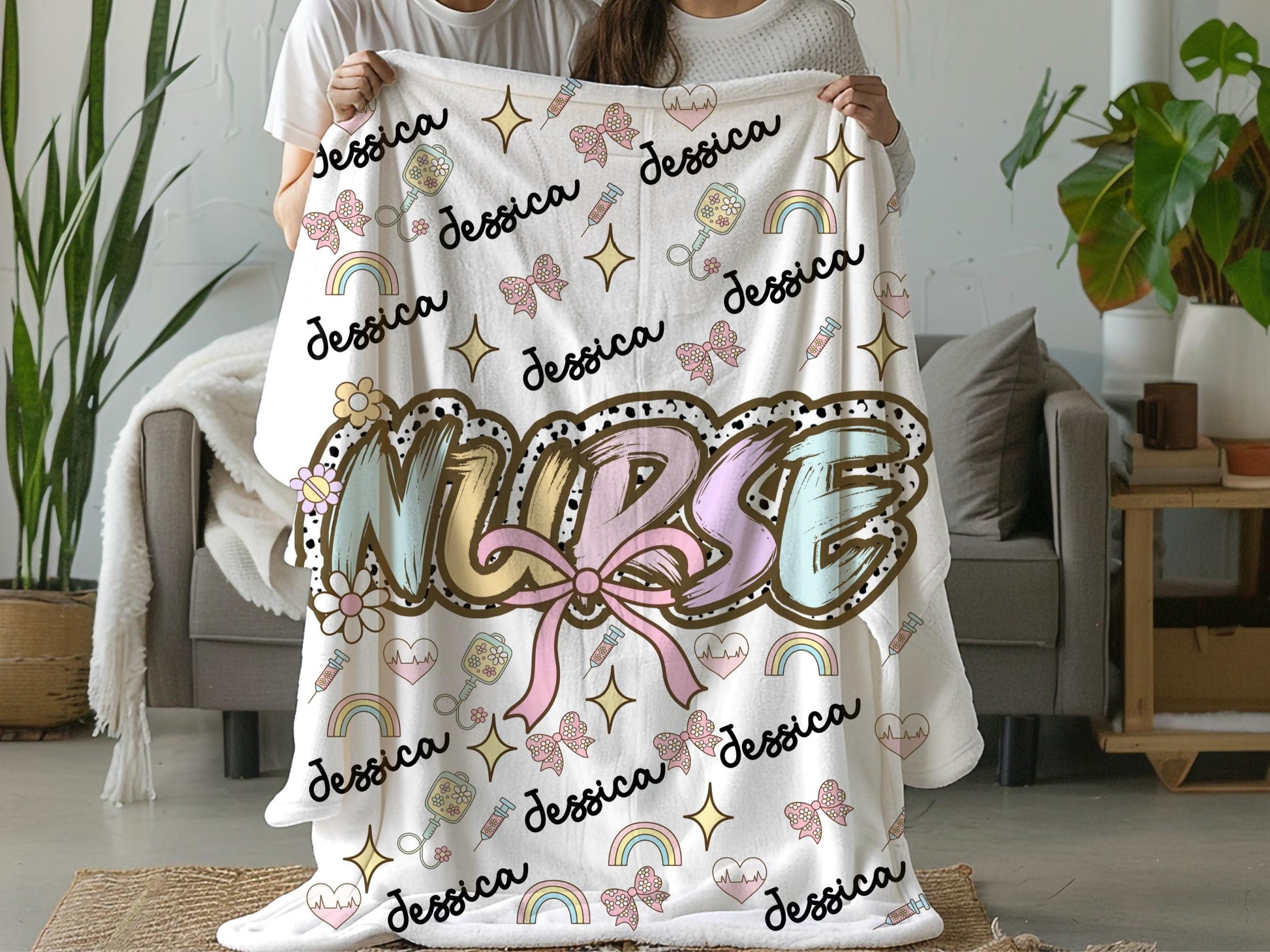 Personalized nurse name blanket  with the word nurse in a pastel dalmation dot  print and pink bow, with name and nurse accessories surrounding perfect gift for nurses