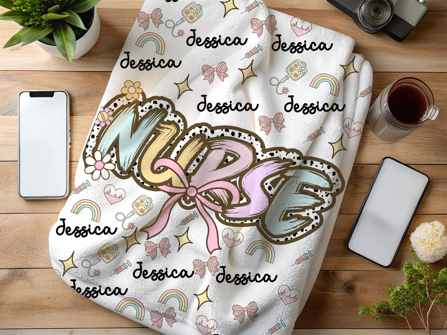 Personalized nurse name blanket  with the word nurse in a pastel dalmation dot  print and pink bow, with name and nurse accessories surrounding perfect gift for nurses