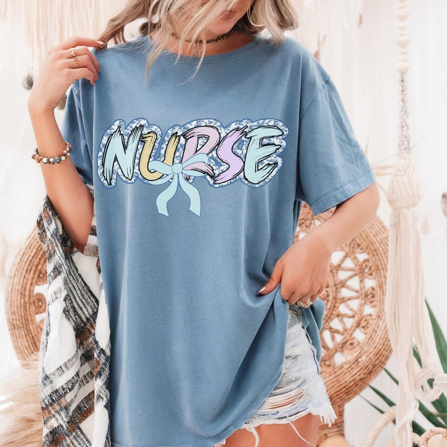 Women’s blue nurse t-shirt with the word nurse in a pastel blue floral print, gift for nurses