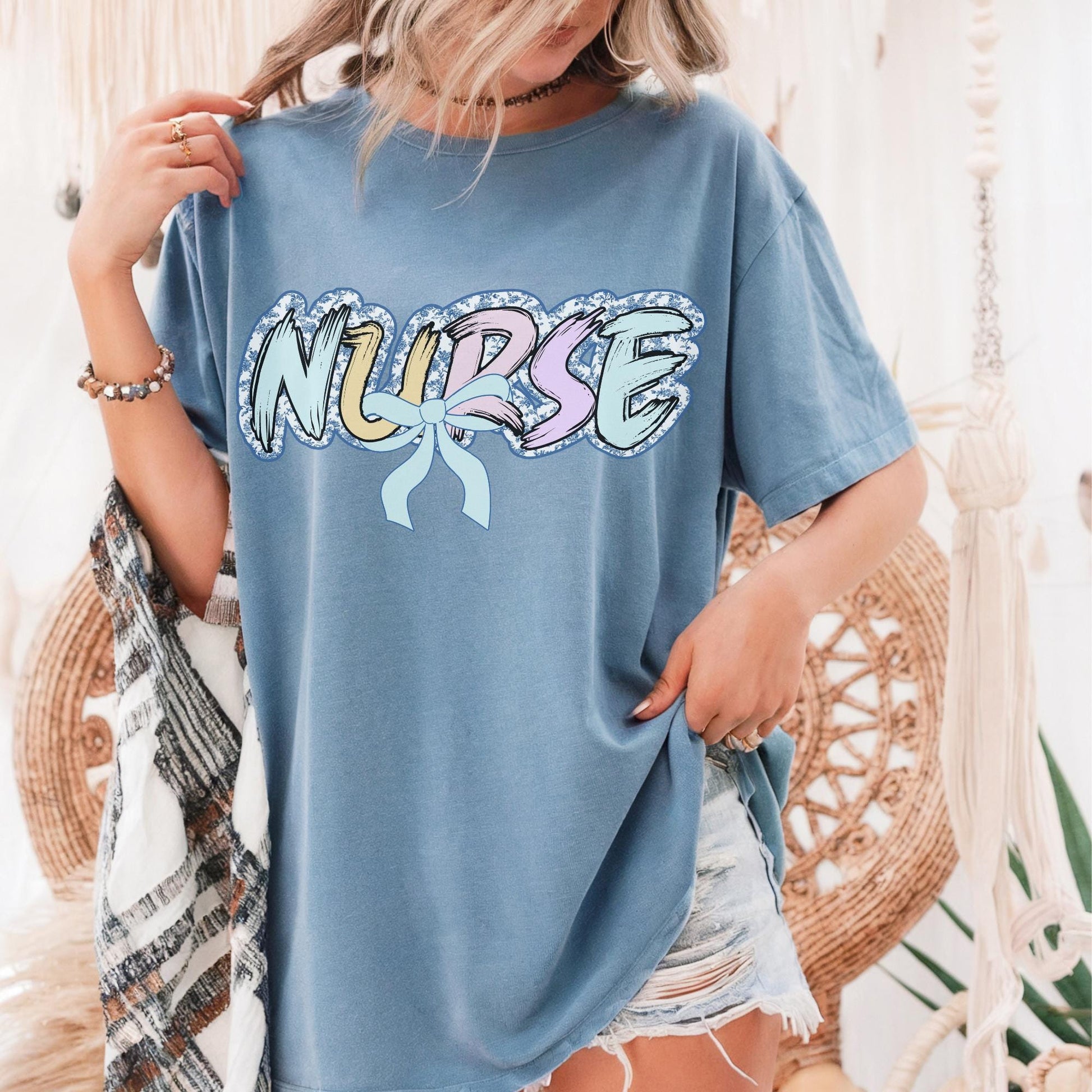 Women’s blue nurse t-shirt with the word nurse in a pastel blue floral print, gift for nurses